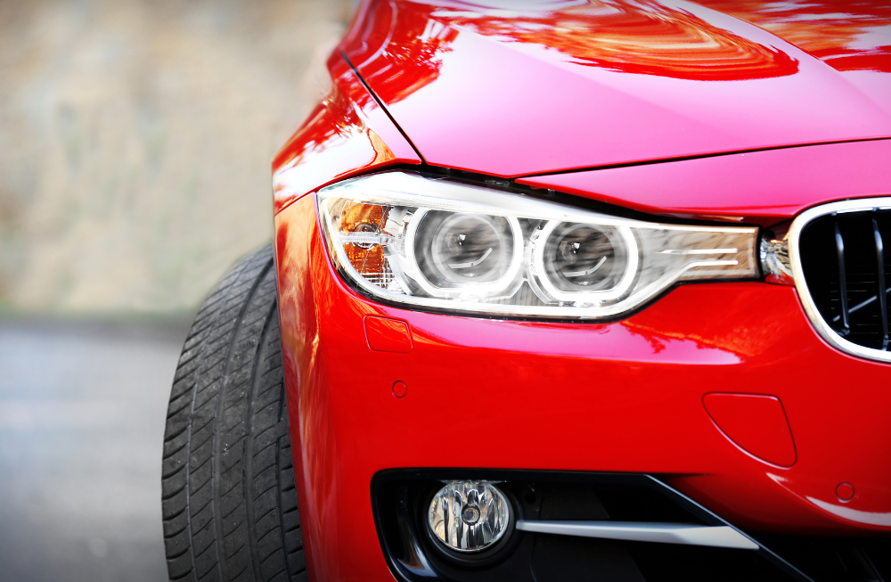 Ceramic coating for cars - front portion of a shiny red car