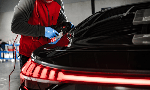 Car Waxing in Las Vegas - technician waxing a black car