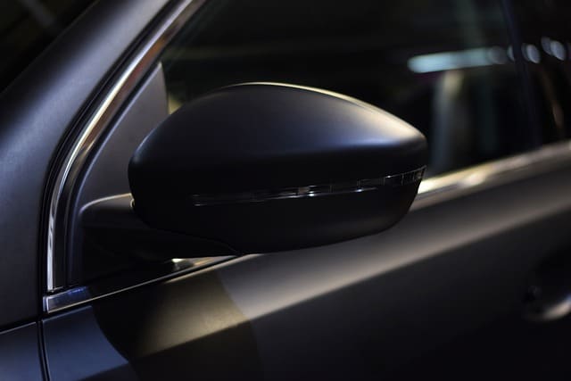 Tinted Car Windows - Close up the driver's side of a black car with tinted windows