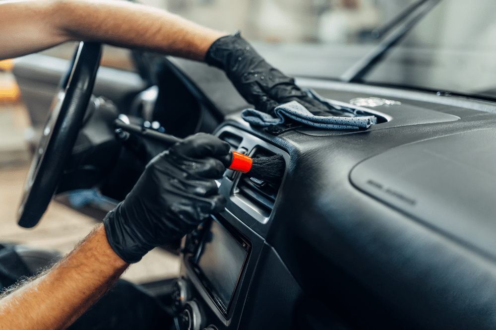 employee performing auto interior detailing