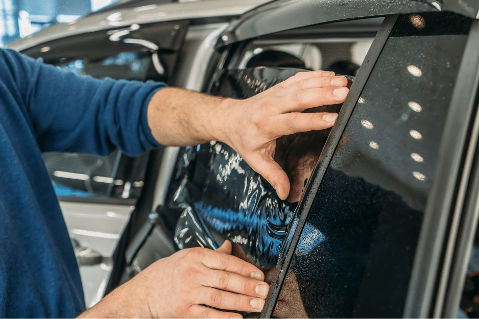 technician applying auto glass tinting