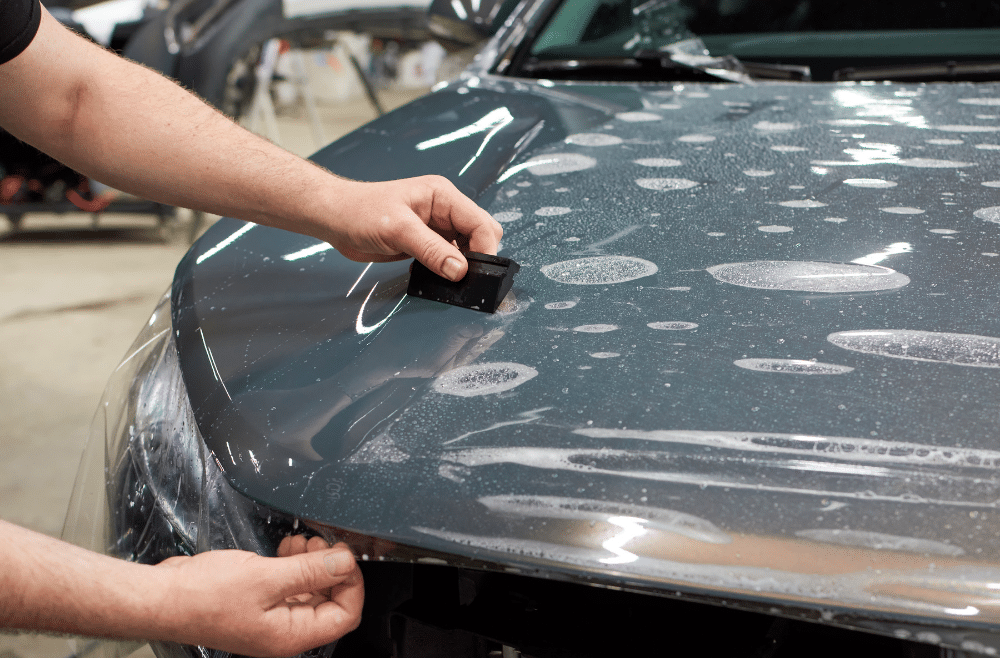 Technician performing clear bra installation